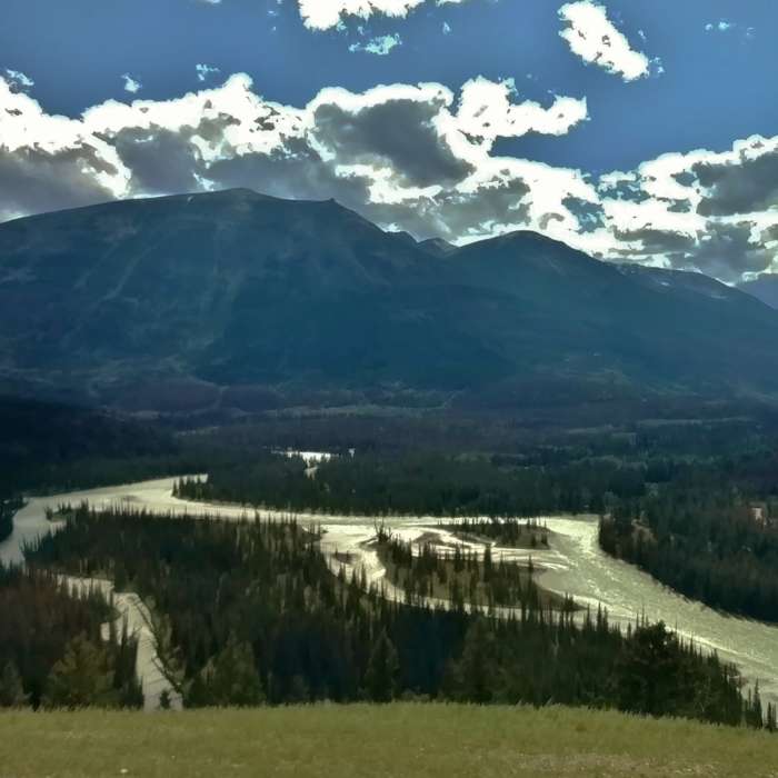 Whistlers Summit looms over the Athabasca River far below, when looking southwest from the western viewpoint along the Old Fort Point Loop trail. Near Old Fort Point Loop