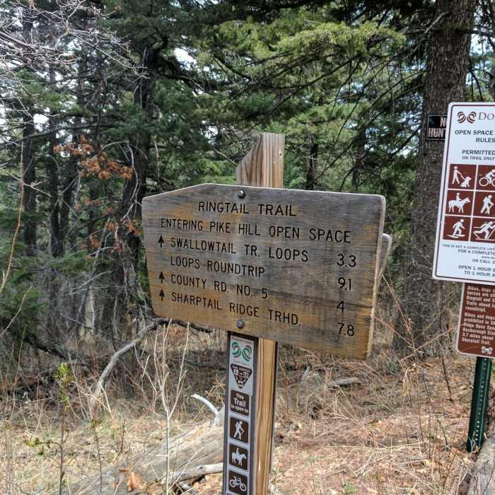 A sign marking the boundary between the National Forest and the the Pike Hill Open Space. Near Ringtail Trail #699
