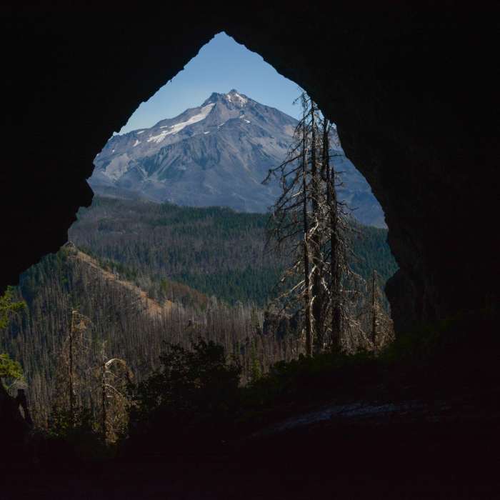 Boca Cave's entrance perfectly frames Mount Jefferson. Near Boca Cave