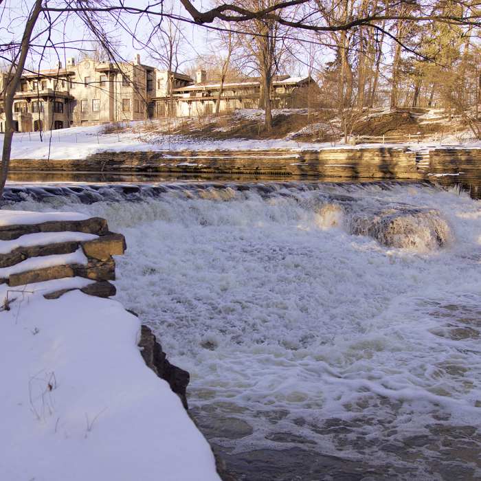 A broad falls cascades behind Henry Ford Estates. Near Ford Field Park