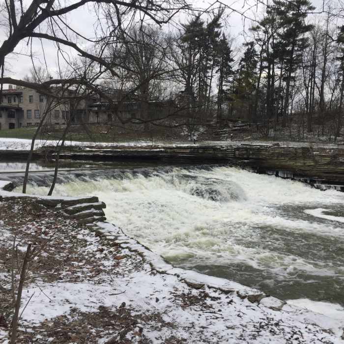 A broad waterfall cascades behind Henry Ford Estates. Near Ford Field Park