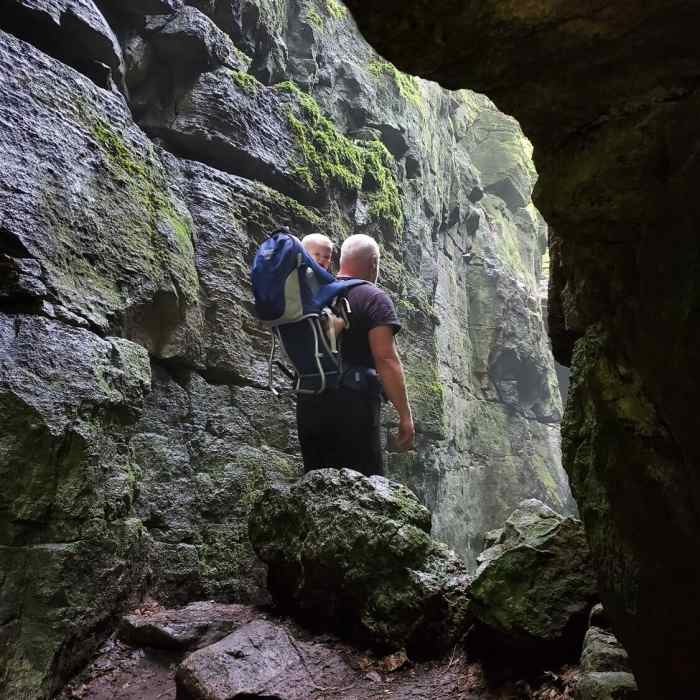 Man and baby in a cave. Near Singhampton Caves Loop
