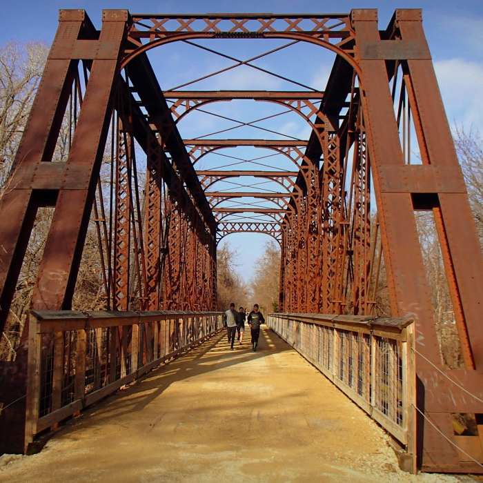 Runners cross the Elm Creek Bridge on the Southwind Rail Trail near Iola, Kansas. Near Southwind Rail Trail