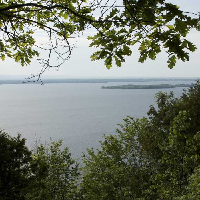 "Lake Champlain from Eagle Mountain's Hoyt Lookout looking towards the Adirondacks" by Michelle (https://www.flickr.com/photos/30387039@N05/) licensed under CC-BY-ND 2.0 (https://creativecommons.org/licenses/by-nd/2.0/) Near Hoyt Lookout-Eagle Mountain Loop