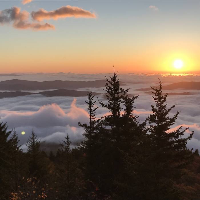 Sun rising over the cloud encased South Toe River Valley as the wind begins to whip up the just moments before still clouds as seen from Sunrise Point along the Woody Ridge Trail Near Woody Ridge Trail (177)