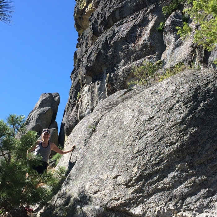 An adventurer checks out the huge rock formation. Near Upper Stack Rock Trail