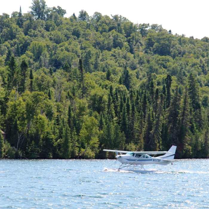 A seaplane daintily lands on the water near Windigo. Near Windigo Nature Loop