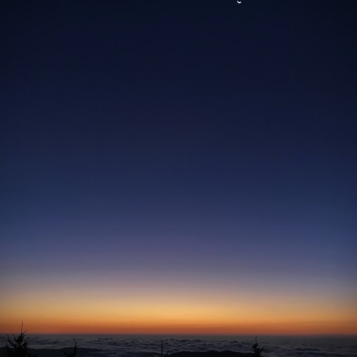 Pre-dawn sky looking east from Woody Ridge Trail with the moon and Venus (barely visible in the middle) in the sky and the South Toe River Valley below covered in early morning low cloud cover. (10/15/17) Near Woody Ridge Trail (177)