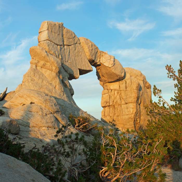 Arch Rock in the morning light. The opening is about 30 feet tall and the entire formation may be 40 - 50 feet tall. Near Margaret Lakes Trail #26E03