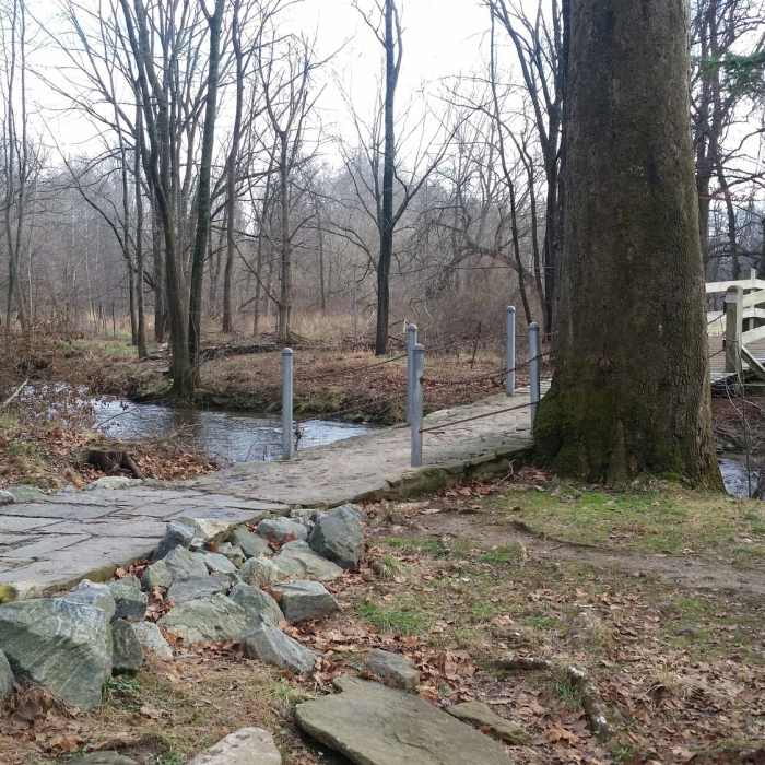 Bridge over Valley Creek. Much of the trail is large pavers Near Valley Creek and Knox Farm
