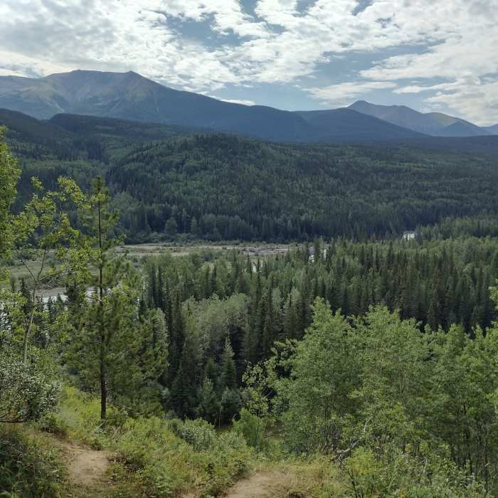 The Smoky River is seen below with a backdrop of the forested mountains on the way to Eaton Falls. Near Eaton Falls
