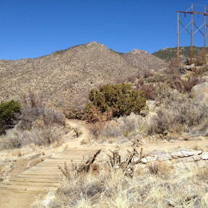 A wooden bridge over an arroyo on the Lower Foothills Trail 365. Near Embudo Horse Trail