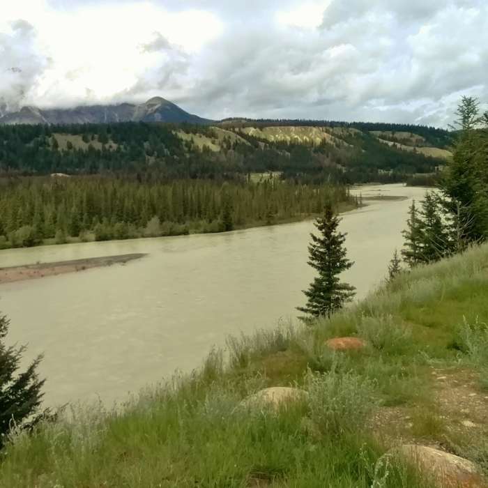 The Athabasca River looking northwest from the Athabasca River Trail. Pyramid Mountain is hidden in the clouds on the left. Near Athabasca River Trail
