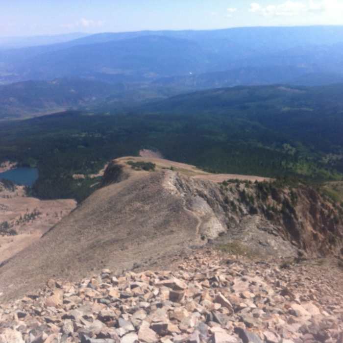 Looking down the talus field to the Roaring Fork Valley on the Mount Sopris Trail. Near Thomas Lakes