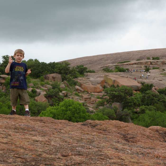 Gabriel climbing Enchanted Rock Near Interpretive Loop