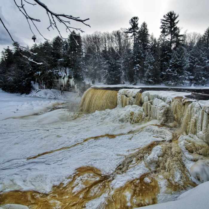 Mostly-frozen Tahquamenon Falls in winter from the primary viewing platform. Near Tahquamenon Falls Route