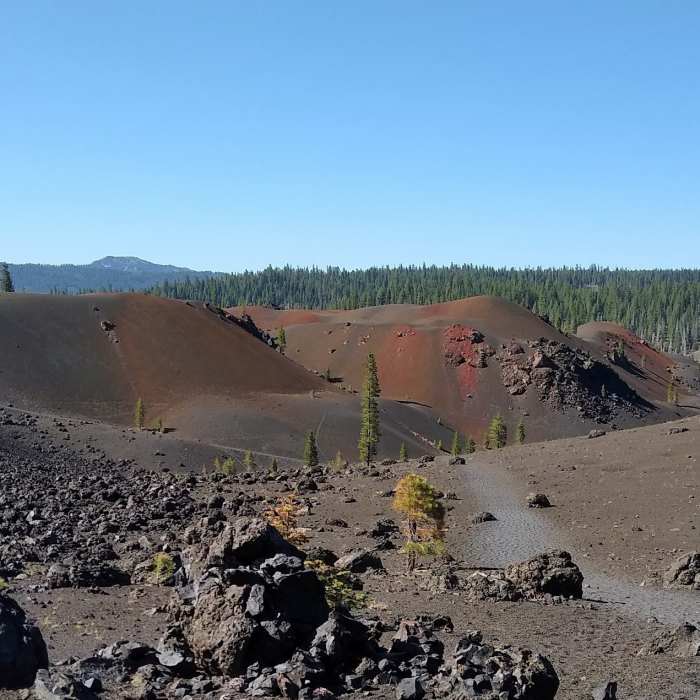 Approaching the Painted Dunes (center) from the north on Butte Lake to Snag Lake Trail (West). Mount Harkness (center left), 8,046 ft., is in the far distance to the south. Near Cinder Cone Trail