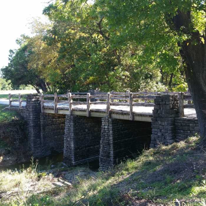 Iconic CCC bridge featured in park souvenirs such as path tags and shirts. Near Spillway Hiking Trail
