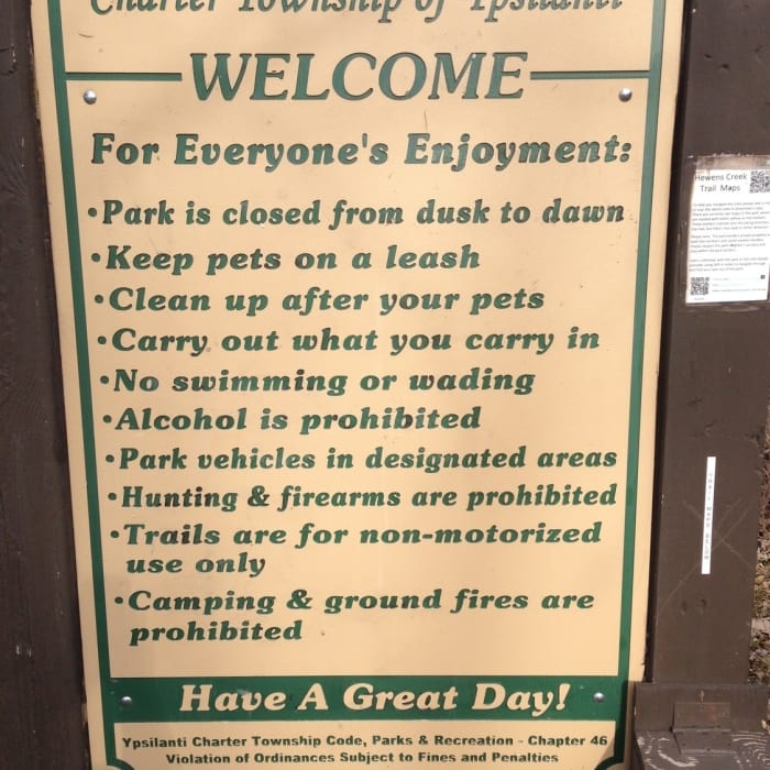 A trailhead sign details the rules at Hewen's Creek Park. Near Hewen's Creek Park