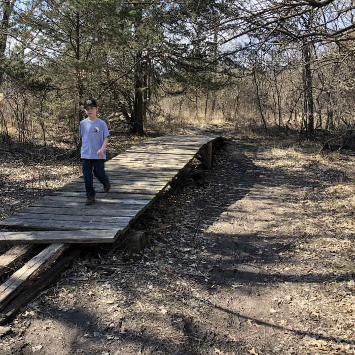 This section floods and the bridge has been here at least 15 years...its floated off it's original location and fallen apart a bit...but still can get you across the mudhole when you need it! Near Prairie Sunset Trail
