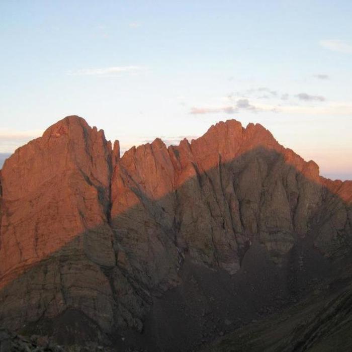 A stunning view of Crestone Needle (left) and Crestone Peak (right), with morning alpenglow above the shadow of Humboldt Peak. Near Crestone Peak South Face
