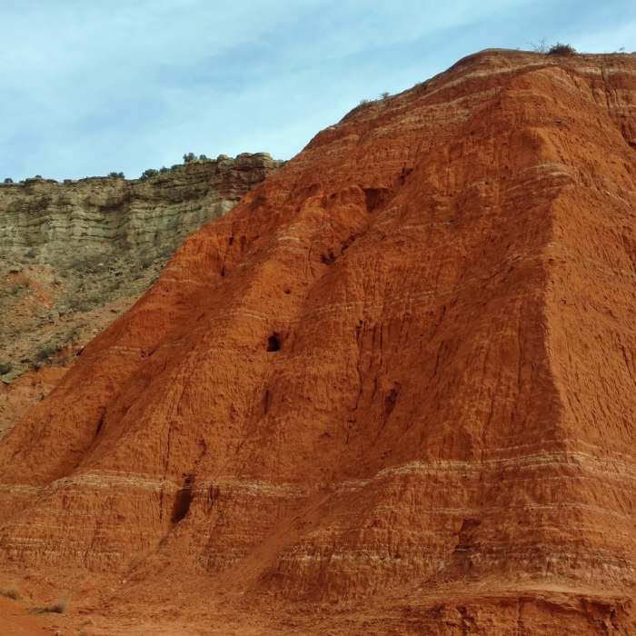 The various colors of the canyon wall layers up close, at the base of Fortress Cliffs on Comanche Trail North. Near Kiowa Trail