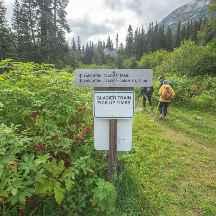 Trailhead sign and train times on the reverse side of the sign. Near Laughton Glacier Trail