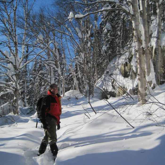 Julian at base of the cliff on D1. Near Snowshoe Route #6