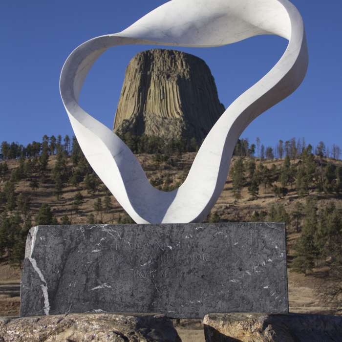 Viewing Devils Tower through the Circle of Sacred Smoke sculpture. Near South Side Trail