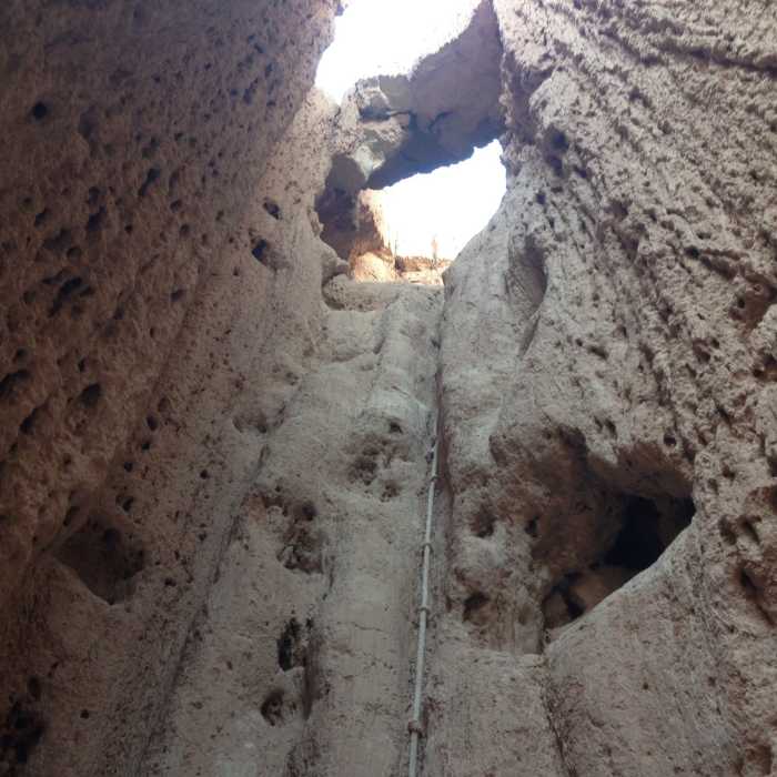 A rope that leads up and under a natural bridge in the back of one of the slot canyons in the Moon Caves section of the park (to access this, you need to crawl through a small underground passage that then opens up into this canyon) Near Miller Point Caves Loop