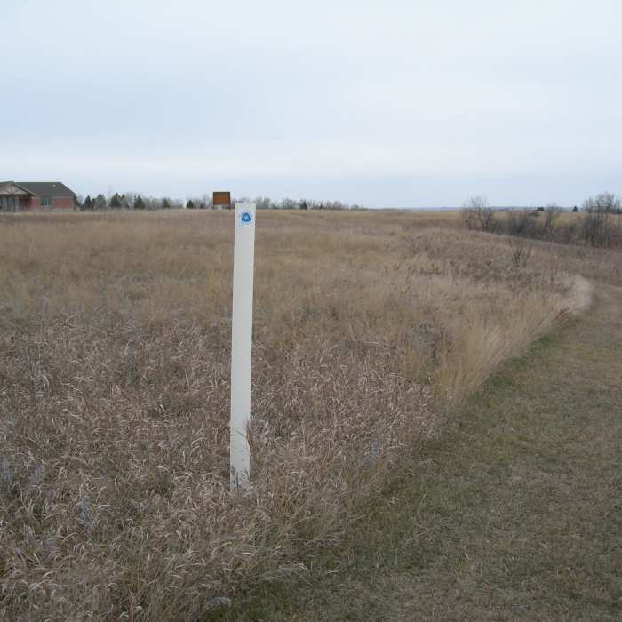 The white posts with the white/blue triangle mark the North Country Trail. For westbound NCT travelers, this is the end. Near North Country Trail Western Terminus Loop