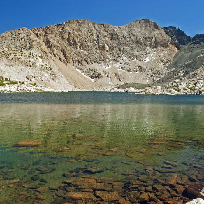 Lake 10918 below Emerald Peak. It is possible to scramble up the dark rock at the far end of the this lake to another lake above 11200 feet directly below the vertical cliffs of Emerald Peak. Near Emerald Peak Lakes Route