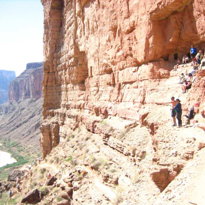 Hikers approaching the granaries Near Nankoweap Granaries