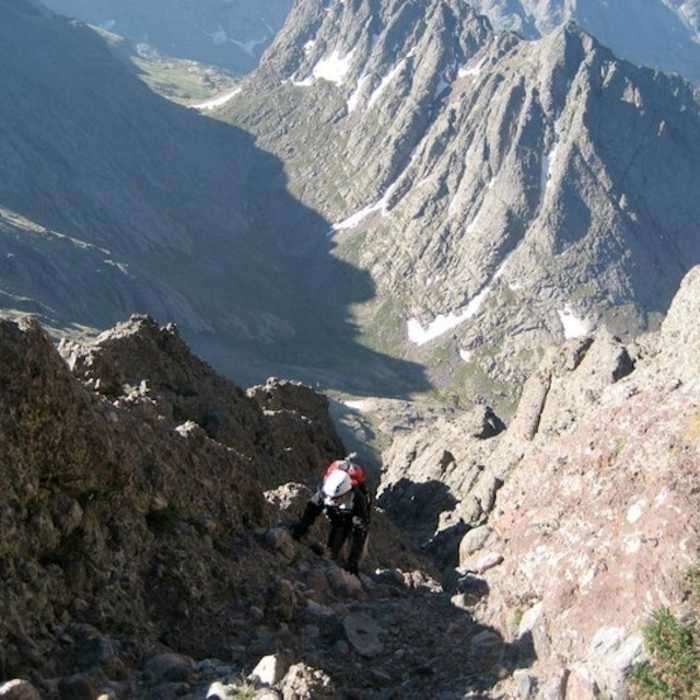 A hiker popping out of the west gully just before reaching the summit. Near Crestone Needle South Face
