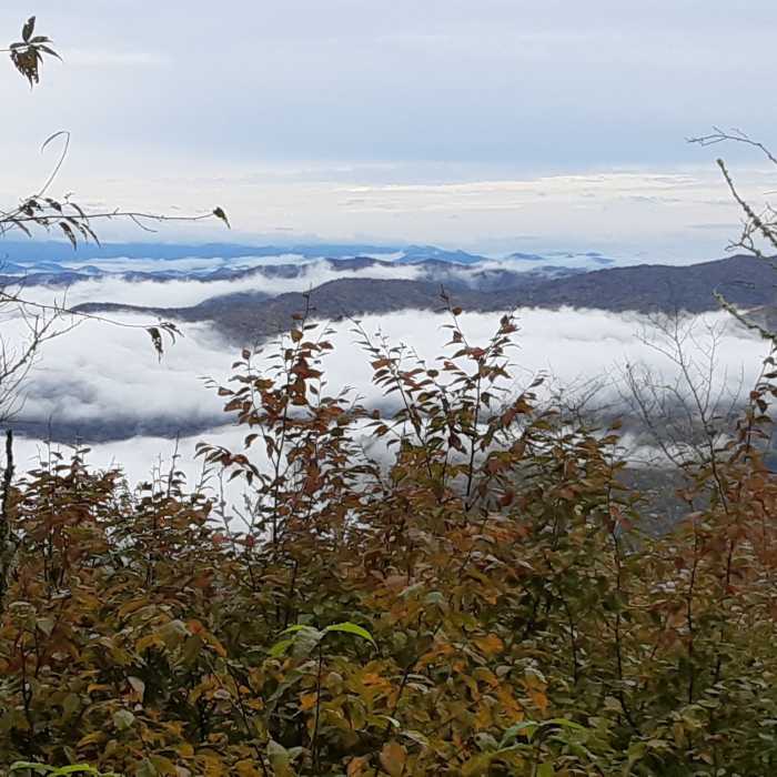 Mountains rising above the clouds. Near Carmen AT Loop